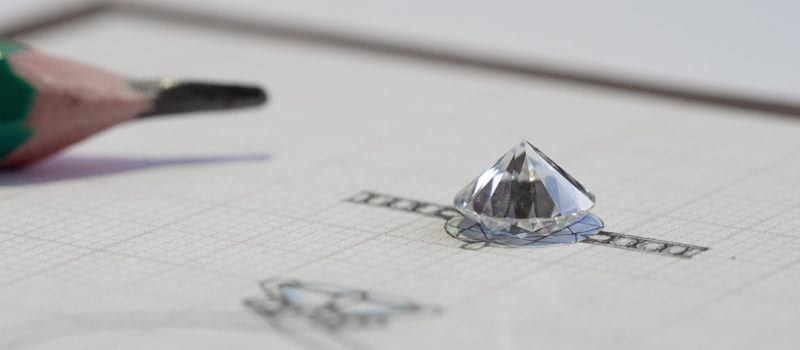 Sketch of a diamond ring with ethically sourced diamond on top of the to scale sketch